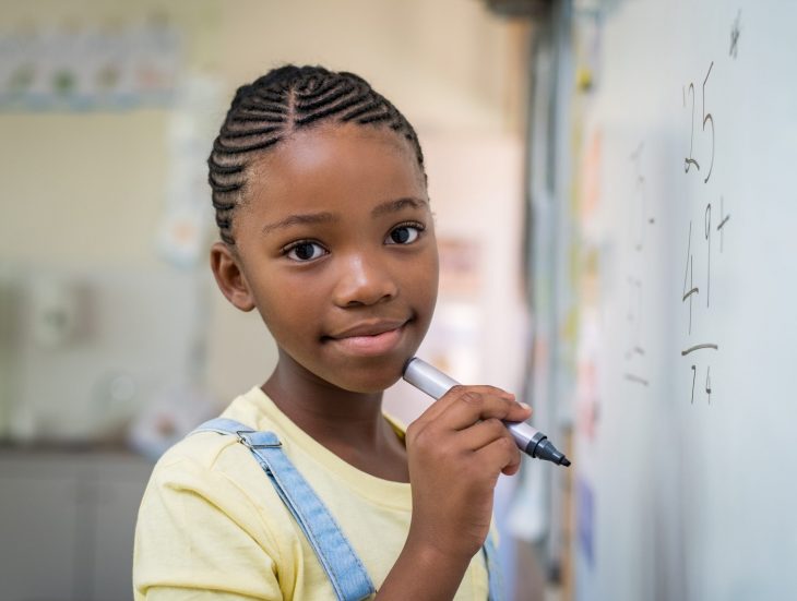 Girl doing math at whiteboard