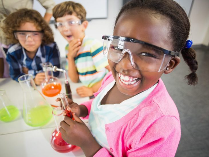 Kids doing a chemical experiment in laboratory