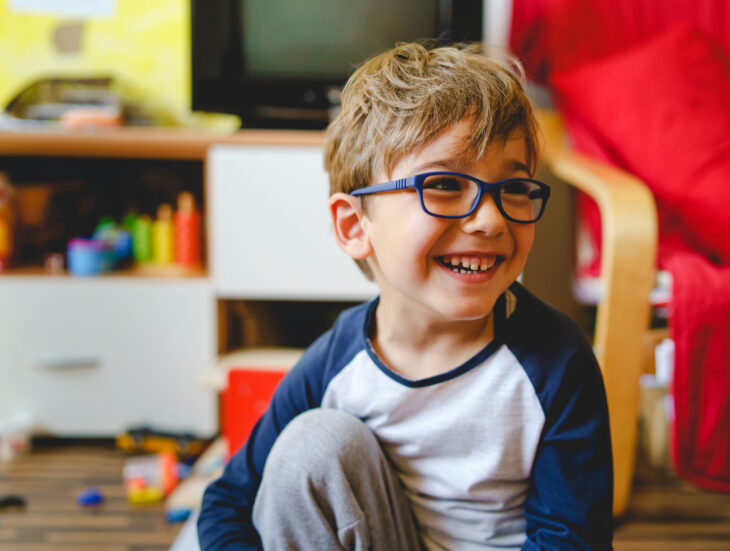 Happy small caucasian boy four years old smiling at home